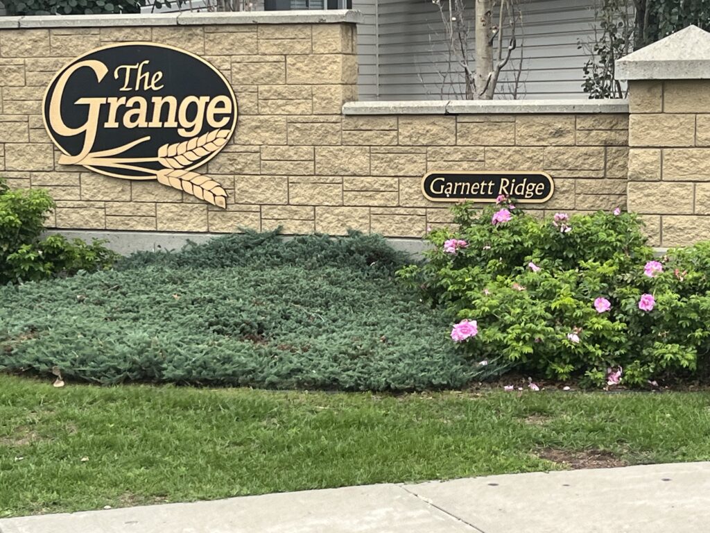 The Sign for the Grange Apartment Complex Stands Prominently in Front of the Building
